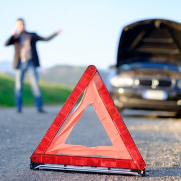 autopom! extended car warranty man on the phone red triangle sign car breakdown car by the side of the road with open hood